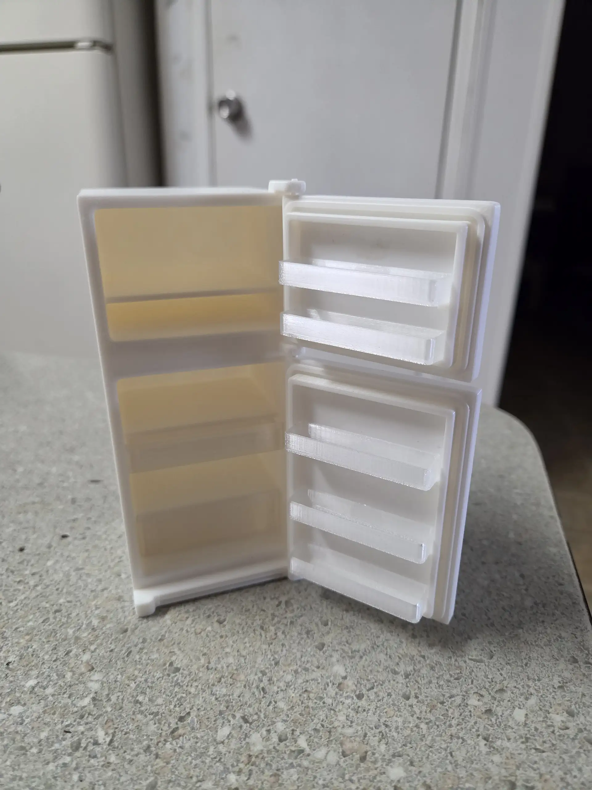 Classic dollhouse refrigerator with open doors and interior shelves