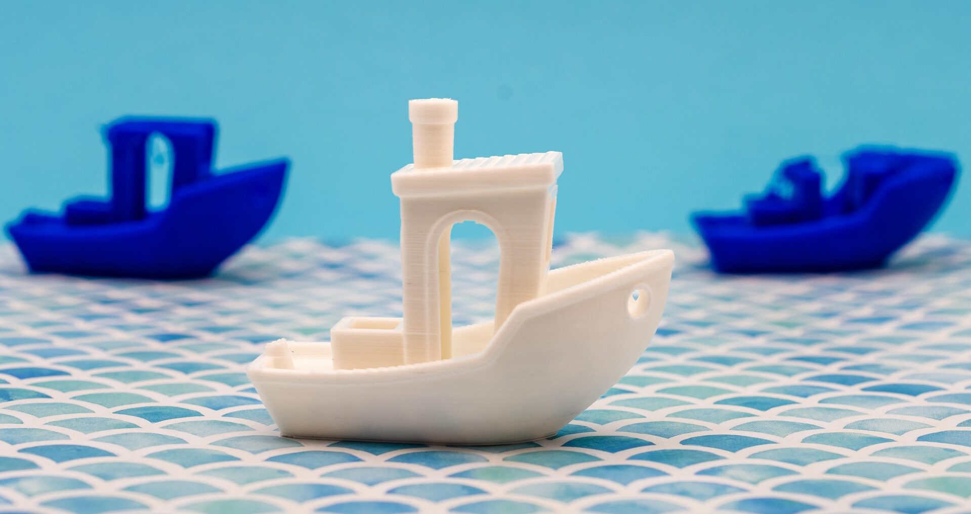 3D Benchy boats printed in multiple colors showing popular FDM calibration print