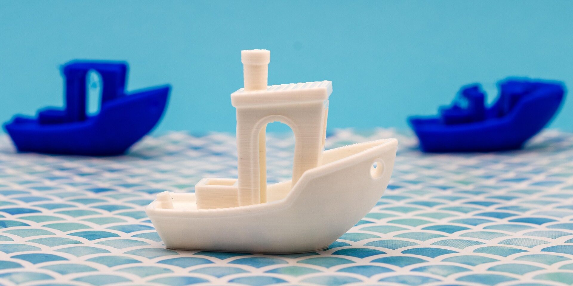 3D Benchy boats printed in multiple colors showing popular FDM calibration print
