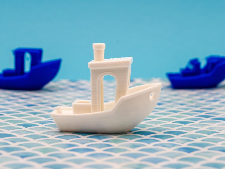 3D Benchy boats printed in multiple colors showing popular FDM calibration print
