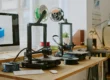 FDM 3D printing machines on office desk near computer workstation