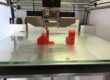 3D printer with glass print bed showing bed surface type for FDM printing